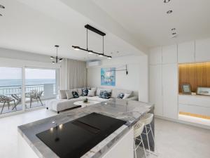 a living room with a couch and a table at Ciel Collection - Luxury Seafront Living in Perea