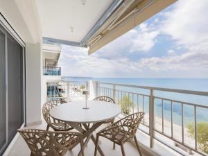 a balcony with a table and chairs and the ocean at Ciel Collection - Luxury Seafront Living in Perea