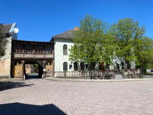 a large white building with a fence in front of it at Fortuna Inn Salzmünde in Salzatal