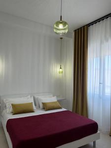 a bedroom with a large bed and a window at Trapani Urban Nest in Trapani