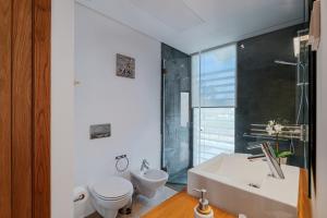 a bathroom with a toilet and a sink at Ocean Village Eden in Troia +18 photos