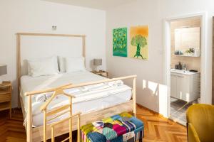 a bedroom with a bed and a chair at House Erin Tara Sigrid, Hvar in Hvar