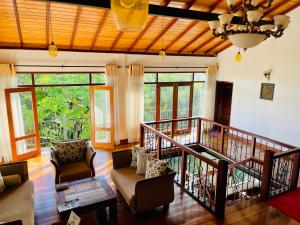 a living room with a couch and a table at The Grand Hanthana in Kandy