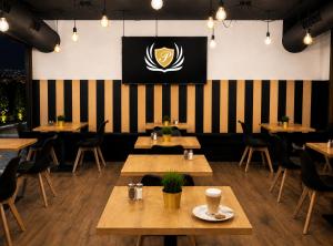 a restaurant with tables and chairs and a flag on the wall at B&B Gdynia in Gdynia
