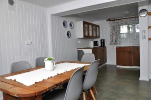 a dining room with a wooden table and chairs at Kaszuby Stężyca holiday cottage in Stężyca