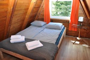 a bedroom with two beds in a log cabin at Kaszuby Stężyca holiday cottage in Stężyca