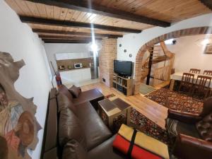 a living room with a couch and a television at Dom Wakacyjny MONA in Małe Swornigacie