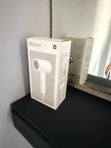a white toilet paper dispenser sitting on a shelf at Uma Pirates Lombok in Mataram