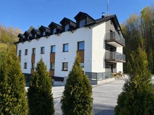 a building with trees in front of it at B&B Gdynia in Gdynia