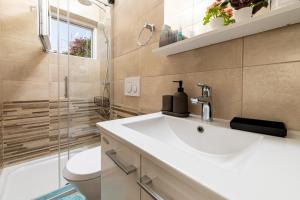 a bathroom with a sink and a toilet and a shower at House Erin Tara Sigrid, Hvar in Hvar