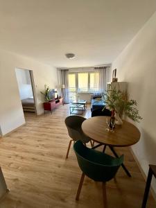 a living room with a table and a couch at Apartament Centrum in Olsztynek
