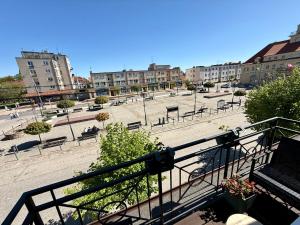 a view of a park with benches and buildings at Apartament Centrum in Olsztynek