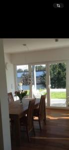 a dining room with a table and chairs and a large window at Top Ferienwohnung Herborn in Herborn +8 photos