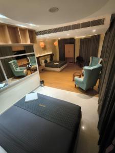 a living room with a couch and a chair and a living room at Hotel Imperia Grand in Mohali