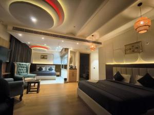 a bedroom with a bed and a living room at Hotel Imperia Grand in Mohali
