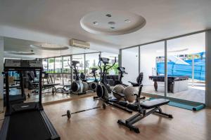 a gym with several treadmills and exercise bikes in it at Blue Diamond Alya Hotel in Alanya