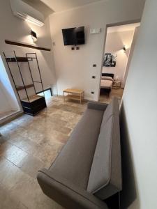 a living room with a couch and a television at Alla botte degli Orsini in Attigliano +18 photos