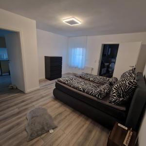 a bedroom with a bed with zebra pillows on it at Monteurzimmer Wohnung in Dillingen an der Saar