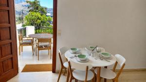 a dining room with a table and chairs and a balcony at Orama Studios in Plakias