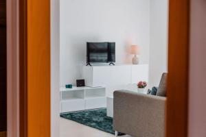 a living room with a tv on a white wall at Apartment - Casa Andres in Salir de Porto