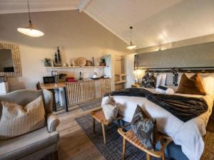 a bedroom with a large bed and a couch at Fever Tree Self Catering in Hillcrest