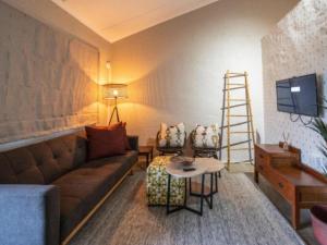 a living room with a couch and a table at Fever Tree Self Catering in Hillcrest