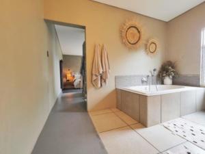 a bathroom with a tub and a sink at Fever Tree Self Catering in Hillcrest +54 photos