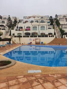 a large swimming pool in front of a large building at Tigert agadir in Agadir +6 photos