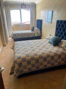 a bedroom with two beds in a room at Tigert agadir in Agadir