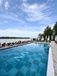 a large swimming pool with chairs and umbrellas at No Stress in Borča