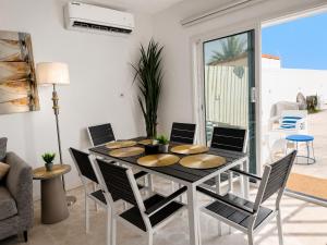 a dining room with a table and chairs at Liora Inside Al Dana beach Resort in Half Moon Bay