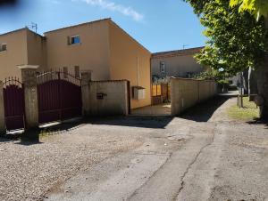 a house with a gate and a fence at Studio en Petite Camargue in Le Cailar +12 photos