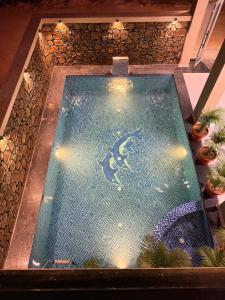 a swimming pool with a shark in the water at Hotel Pushkar Pulse in Pushkar