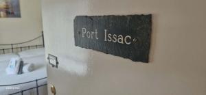 a bathroom door with a sign that reads port issacs at Trehellas House Hotel & Courthouse restaurant in Bodmin