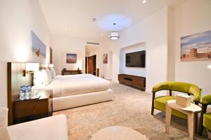 a hotel room with a bed and a tv at Mina Hotel and Residences By The Torch in Doha +75 photos