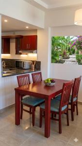 a kitchen with a wooden dining table and chairs at شاليه 2 غرفه in Marsa Alam