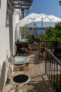 a patio with a table and chairs and a swing at House Erin Tara Sigrid, Hvar in Hvar