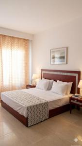 a bedroom with a large bed and a window at شاليه 2 غرفه in Marsa Alam
