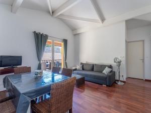 a living room with a table and a couch at Vacancéole - Les Rives du Lac in Lacanau