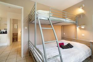 a bunk bed in a room with a ladder at Gite Girolle in Salignac Eyvigues +30 photos