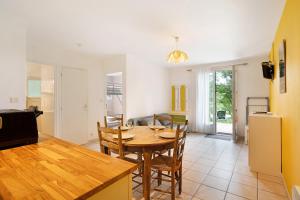 a kitchen and dining room with a table and chairs at Gite Girolle in Salignac Eyvigues