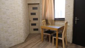 a dining room table and chairs with a brick wall at Dilichella Resort in Dilijan +11 photos