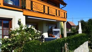 a house with a balcony on top of it at Ferienwohnung Kohler - Königsfeld in Königsfeld