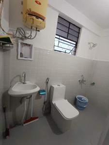 a bathroom with a toilet and a sink at LeeZaiah in Shillong