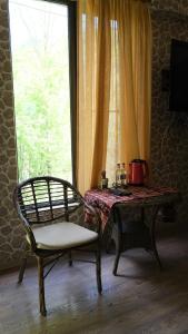 a room with a chair and a table and a window at Dilichella Resort in Dilijan