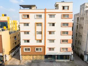 an apartment building in the middle of some buildings at Z Express Aradhana in Bangalore