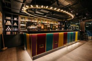eine Bar mit einer farbenfrohen Theke in einem Raum in der Unterkunft Ruby Lucy Hotel London by IHG in London