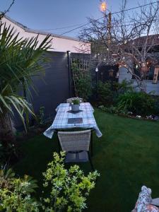 a picnic table in a backyard with a lawn at Grain de folie in Beaune