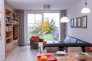 a living room with a couch and a table at Terrasse im Ammergau - Bad Kohlgrub in Bad Kohlgrub