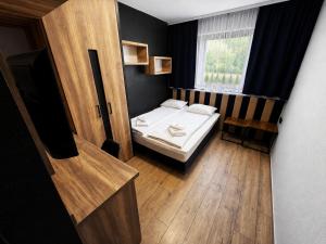 a small bedroom with a bed and a window at B&B Gdynia in Gdynia